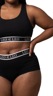 Model wearing AstroWorld Leo Sport Bra Set in Black, front view